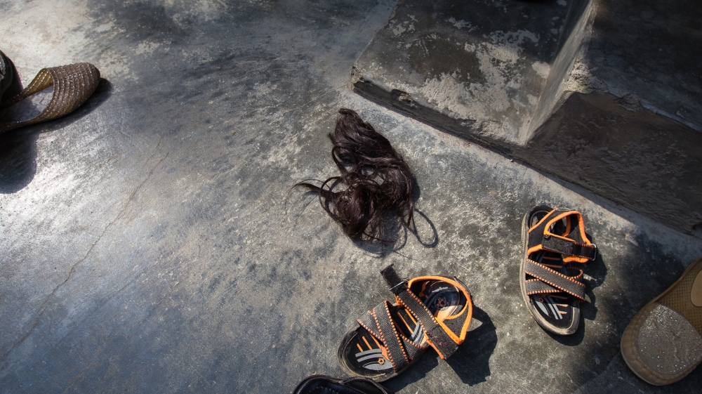 Gulshan's hair lays at the spot where it was allegedly chopped off by the attackers [Baba Tamim/Al Jazeera]
