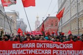 Russian citizens carry a banner reading 'Great October Socialist Revolution' during a rally marking the anniversary of the 1917 Bolshevik revolution in central Moscow, Russia [Maxim Zmeyev/Reuters]