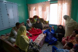 - Gulshan, in shock, is being consoled by the neighbors at her house in Batamalo area of Srinagar, India-administered Kashmir.
