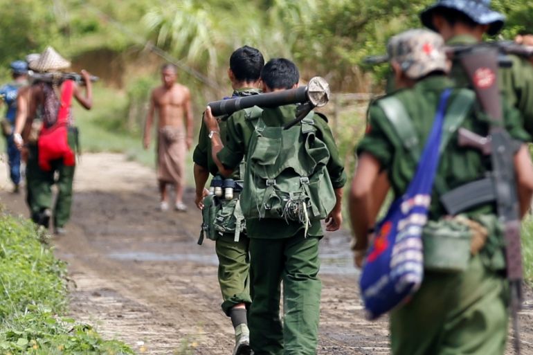 Myanmar soldiers patrol a road in Maungdaw