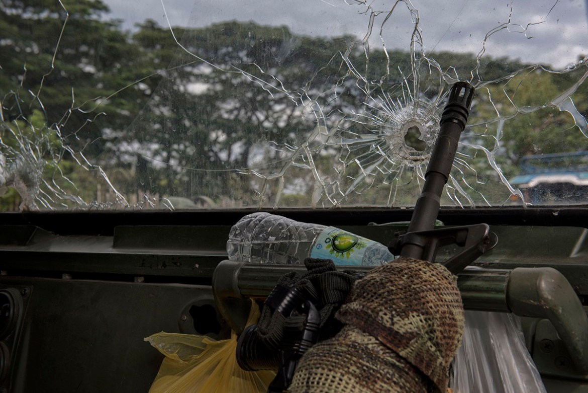 A soldier''s rifle inside a military vehicle with bullet hole ridden windshield as troops get ready to leave the battle against IS-inspired militants on October 20, 2017 in Saguiaran town in Lanao del