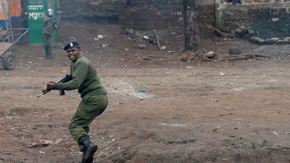 A police officer finds himself amidst an opposition protest in Nairobi [Goran Tomasevic/Reuters]