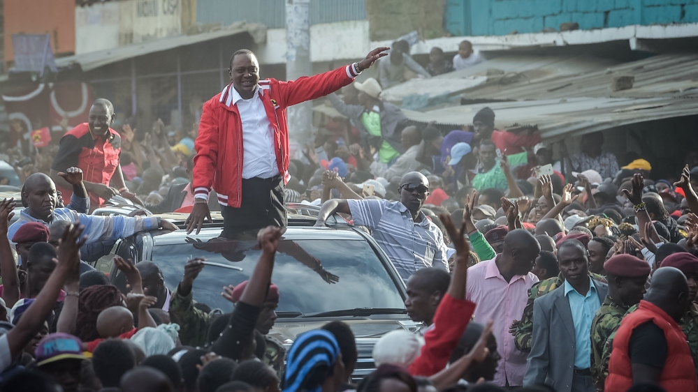Supporters greet Kenya's President Uhuru Kenyatta during a rally in Nairobi on Monday [Simon Maina/AFP/Getty Images]