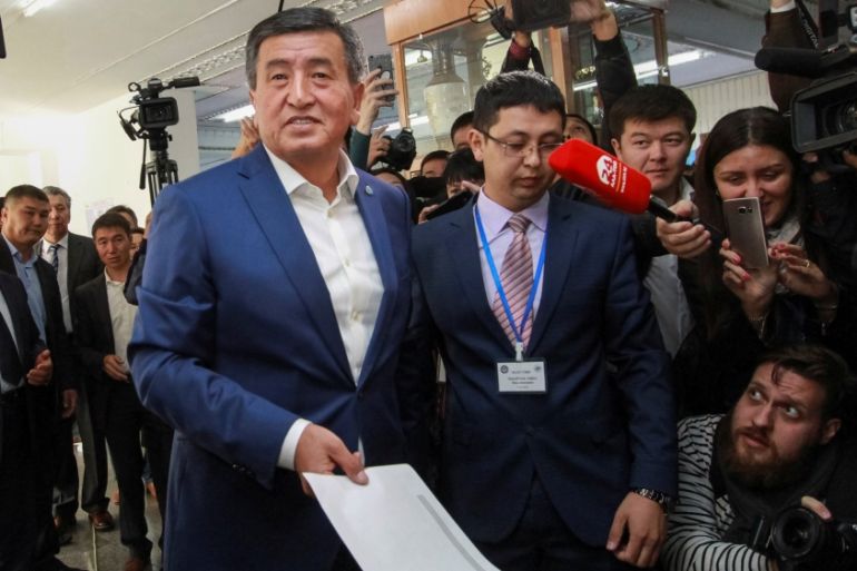 Presidential candidate Sooronbai Jeenbekov casts his ballot at a polling station during the presidential election in Bishkek