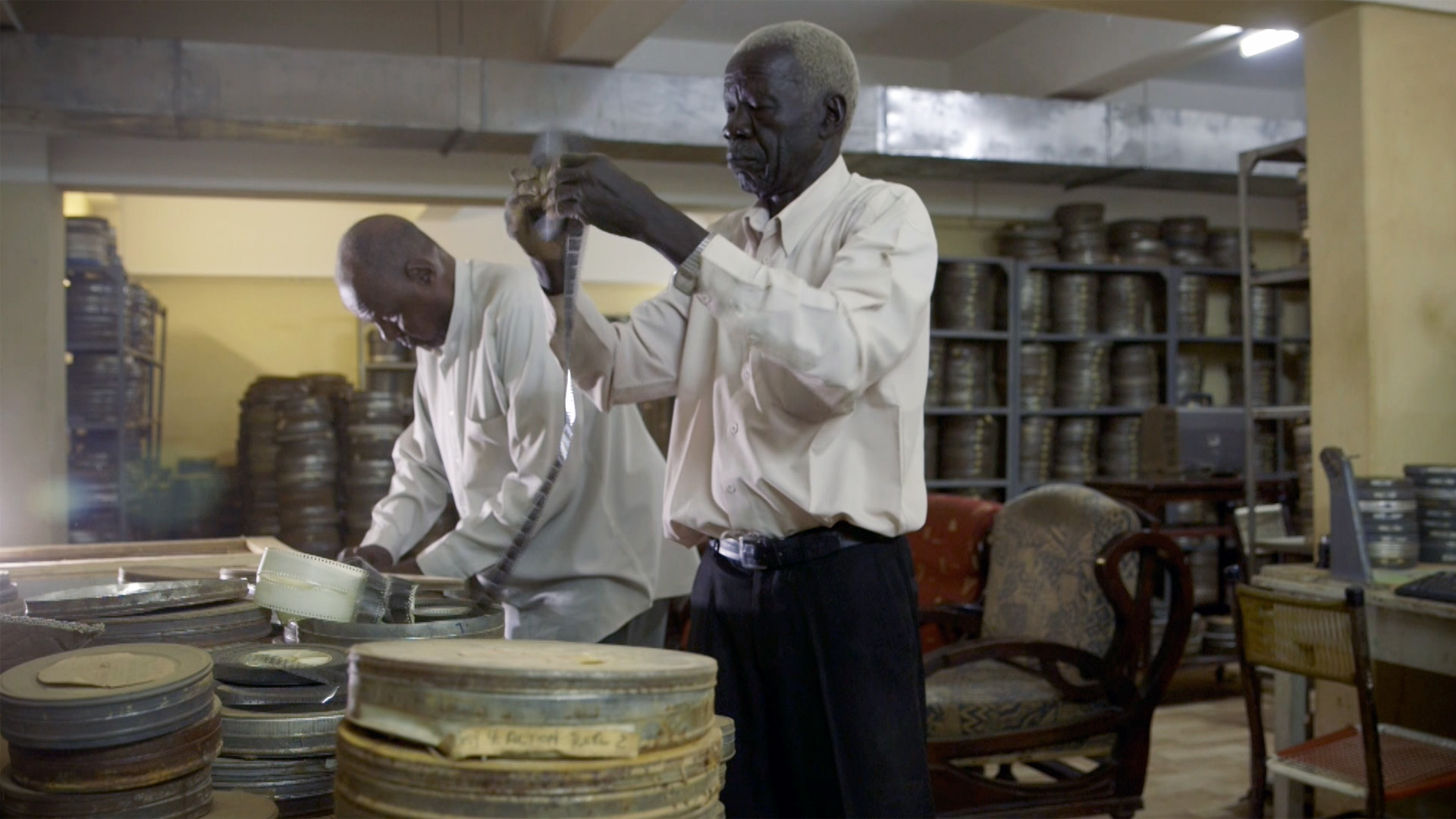 Awad (left) and Benjamin spend their days surrounded by more than 13,000 old films - many of them one of a kind [Screengrab/Al Jazeera]