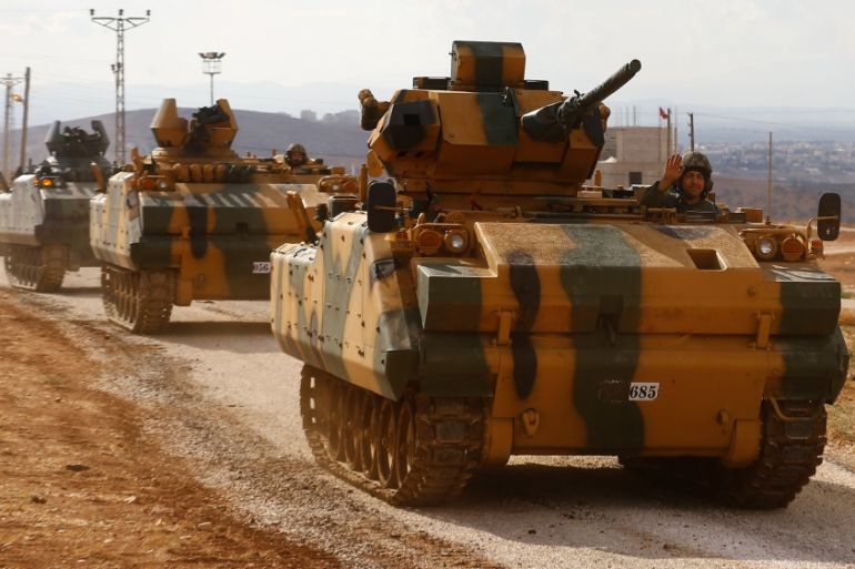 Turkish military convoy drives by village on Turkish-Syrian border line in Reyhanli