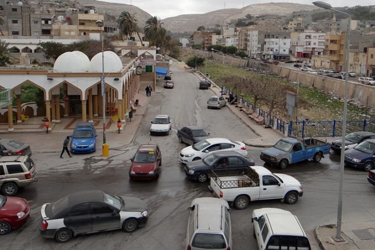 Cars drive in the center of the eastern coastal Libyan city of Derna on February 21, 2016. Seven months after driving the Islamic State group out of Libya''s Derna, militia fighters have blocked roads