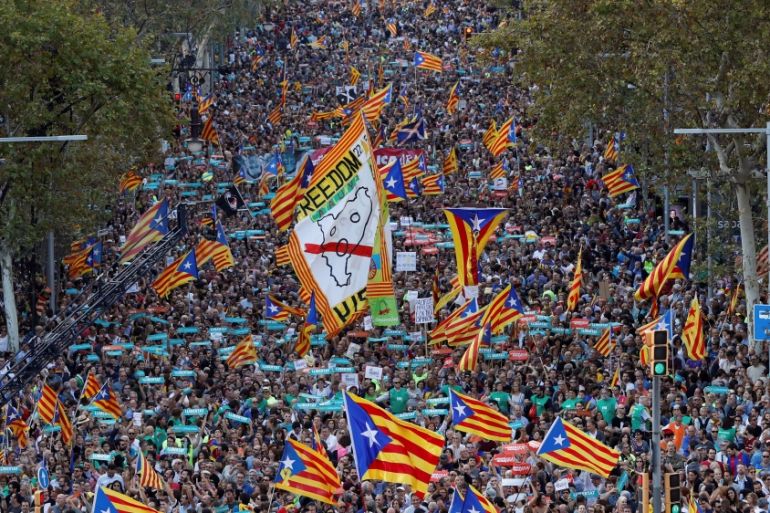 People wave Catalan separatist flags during a demonstration organised by Catalan pro-independence movements ANC (Catalan National Assembly) and Omnium Cutural, following the imprisonment of their tw