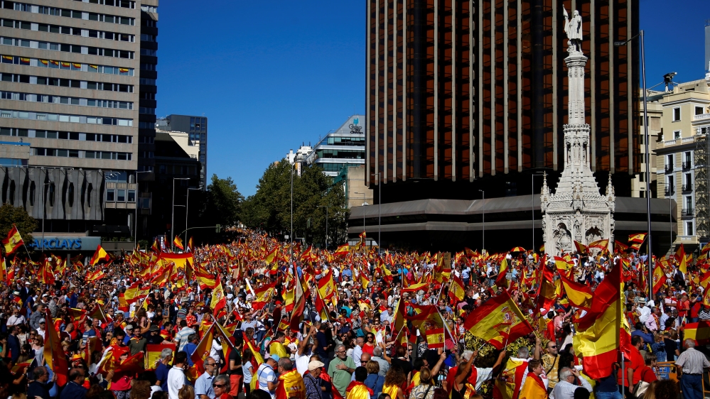 People wave Spanish flags at a pro-unity rally in Madrid [Javier Barbancho/Reuters]