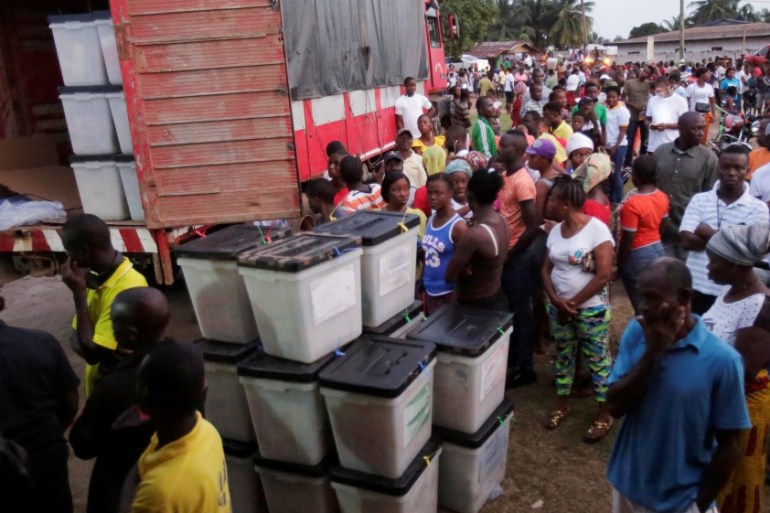 People wait to vote during the presidential election at a polling station in Monrovia, Liberia