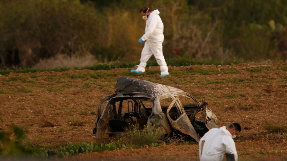 Forensic experts inspect the site of the car bomb blast [Darrin Zammit Lupi/Reuters]