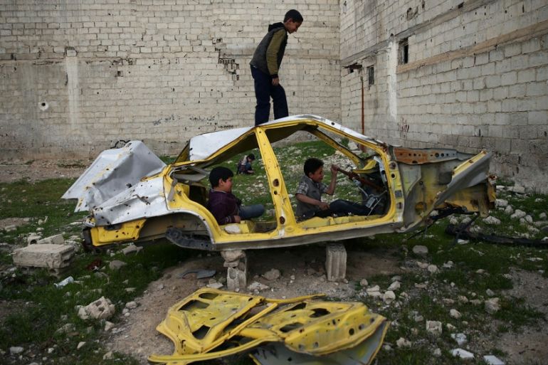 Boys play on a wrecked car in the rebel held besieged Douma neighbourhood of Damascus, Syria April 1, 2017. Picture taken April 1, 2017. REUTERS/Bassam Khabieh TPX IMAGES OF THE DAY