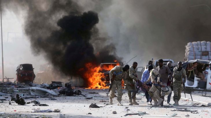 Somali Armed Forces evacuate their injured colleague, from the scene of an explosion in Mogadishu