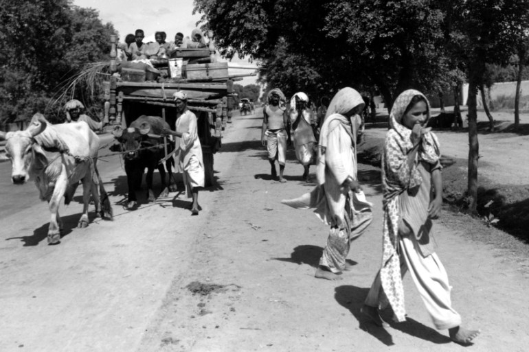 A bullock cart loaded with children and household goods belonging to a Muslim family fleeing from Hindu India moves along a road near Lahore, India on Aug. 26, 1947. The family is travelling to Pakist