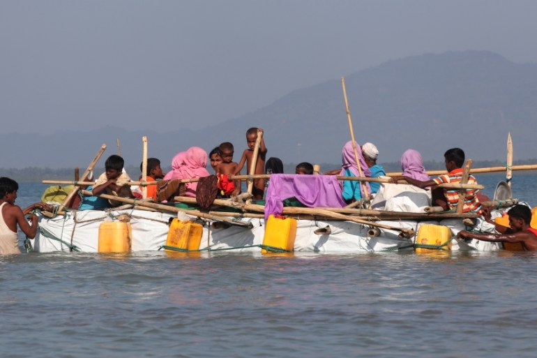 Rohingya refugees sail on an improvised raft across the Naf River to reach Bangladesh, in Teknaf, Bangladesh