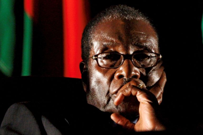 FILE PHOTO - File photo of Zimbabwean President Robert Mugabe watching a video presentation during SADC in Johannesburg