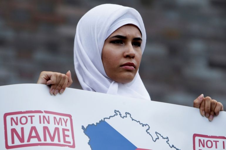 A Czech Muslim holds a banner during a protest rally against terrorism in Prague