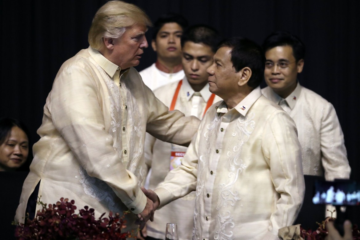 President Donald Trump, left, shakes hands with Philippines President Rodrigo Duterte at an ASEAN Summit dinner at the SMX Convention Center, Sunday, Nov. 12, 2017, in Manila, Philippines. Trump is on
