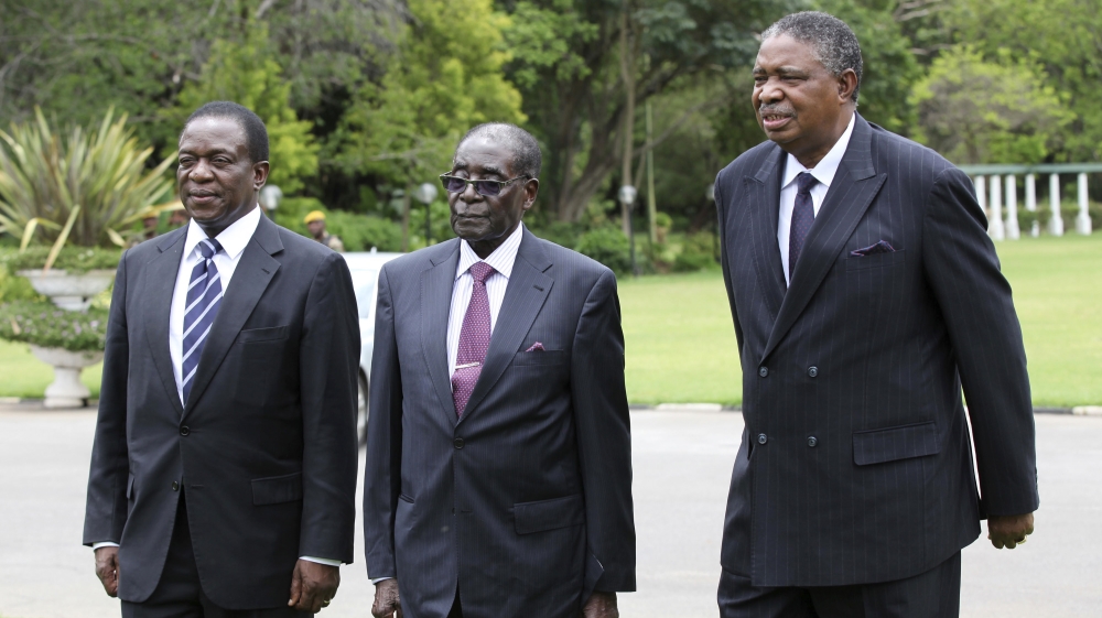 Mnangagwa, Mugabe and Mphoko seen here in a file photo from 2014 [Philimon Bulawayo/Reuters]