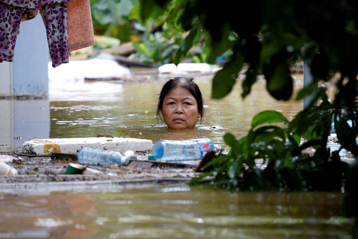 A woman wades through a submerged street in the UNESCO heritage town of Hoi An. The death toll from a typhoon and ensuing floods in Vietnam reached 61 on Monday and the government said some reservoirs