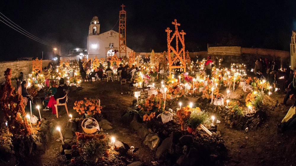 Some cemeteries are covered with flowers as part of the festivity [Misael Valtierra/Al Jazeera]