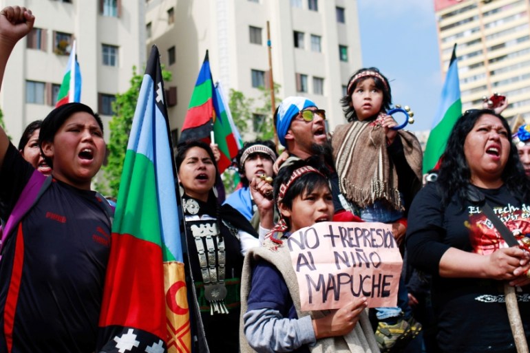 Mapuche Indian and other activists take part in a rally against Columbus Day in downtown Santiago
