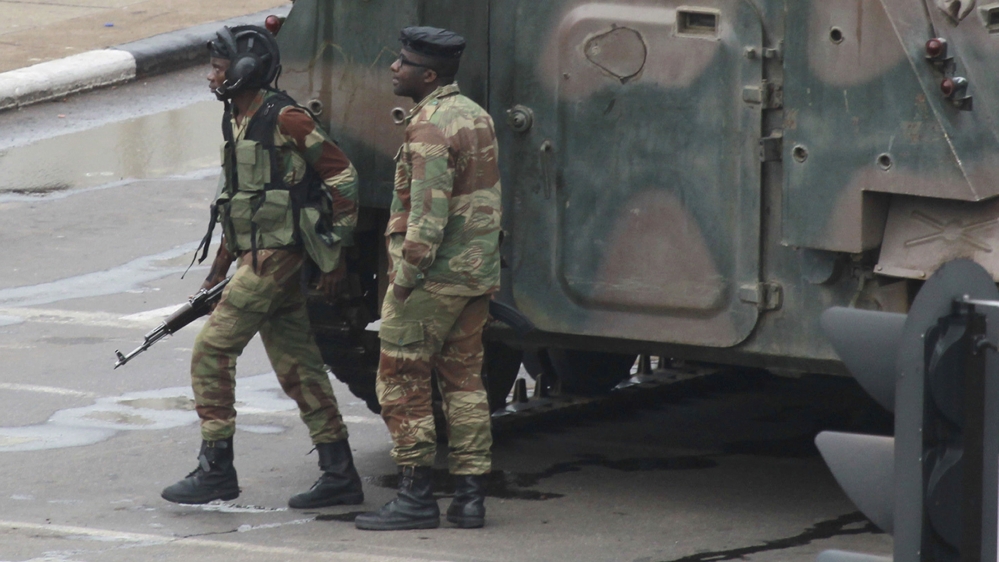 
Armed soldiers on the road leading to Mugabe's office in Harare [Tsvangirayi Mukwazhi/The Associated Press]
