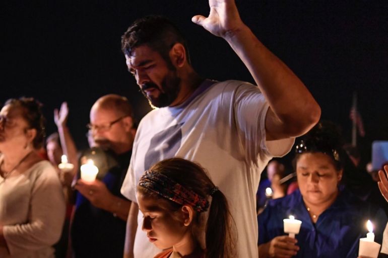 Local residents embrace during a candlelight vigil for victims of a mass shooting in a church in Sutherland Springs, Texas