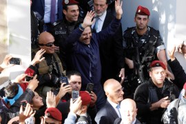 Saad al-Hariri who suspended his decision to resign as prime minister gestures to his supporters at his home in Beirut