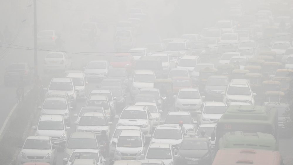 Vehicles drive through heavy smog in Delhi, India [Cathal McNaughton/Reuters]