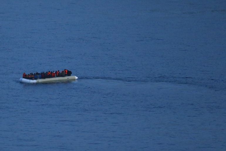 Migrants, aboard a dinghy, sail off for the Greek island of Lesbos as it travels from the Turkish coastal town of Dikili