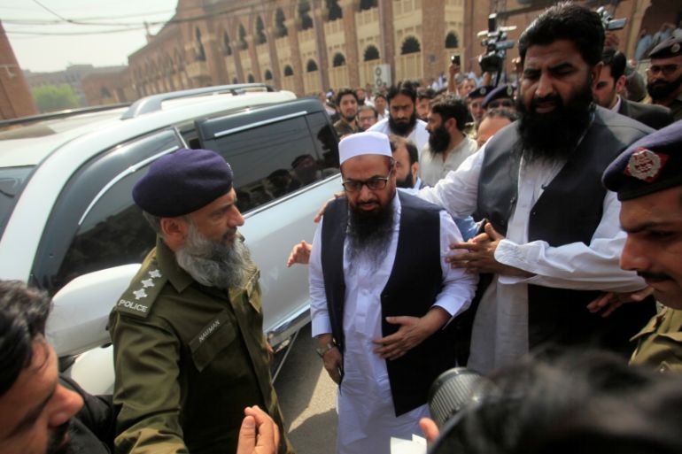 Hafiz Muhammad Saeed, chief of the Islamic charity organisation Jamaat-ud-Dawa (JuD), arrives to appear before a court in Lahore