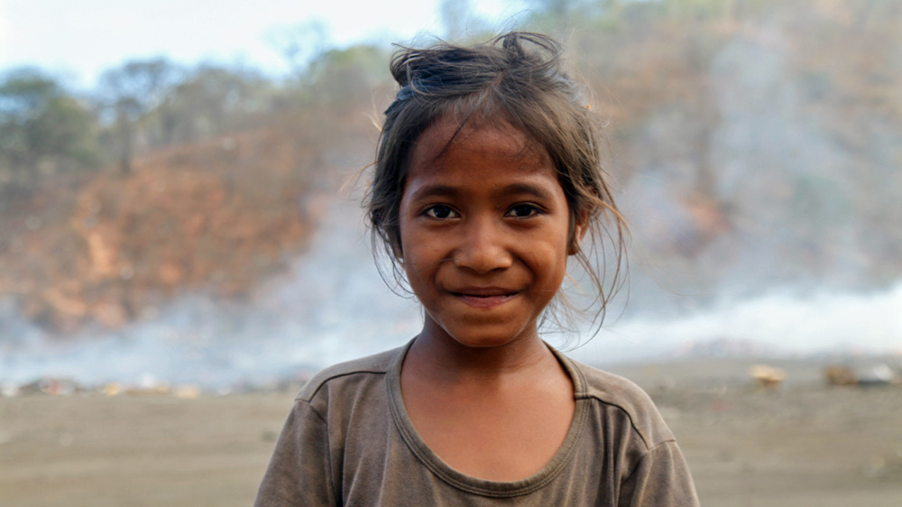 Vanya, 8, lives just outside the dump and says she's been working here all her life [Ian Lloyd Neubauer/Al Jazeera]