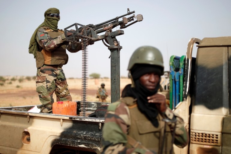 Members of the Malian Armed Forces secure a road during the regional anti-insurgent Operation Barkhane in Inaloglog