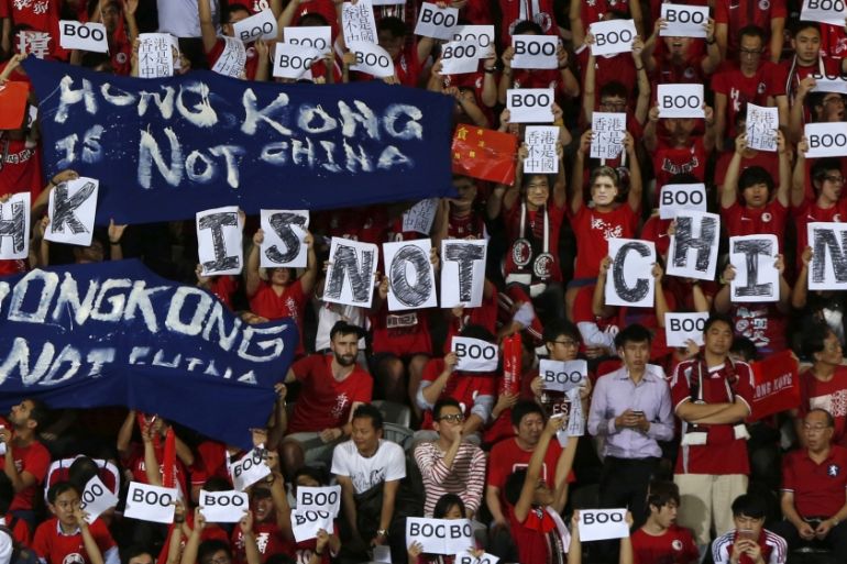Hong Kong fans hold banners and character signs which read "Hong Kong is not China"