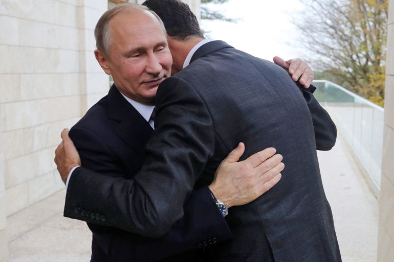 In this Monday, Nov. 20, 2017, photo, Russian President Vladimir Putin, left, embraces Syrian President Bashar Assad in the Bocharov Ruchei residence in the Black Sea resort of Sochi, Russia. Putin ha