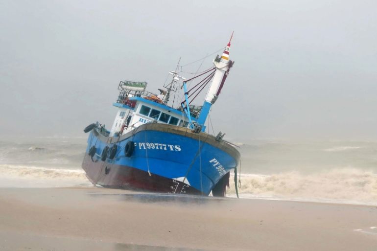 A fishing boat pushed ashore in the central province of Binh Dinh after Typhoon Damrey hit central Vietnam