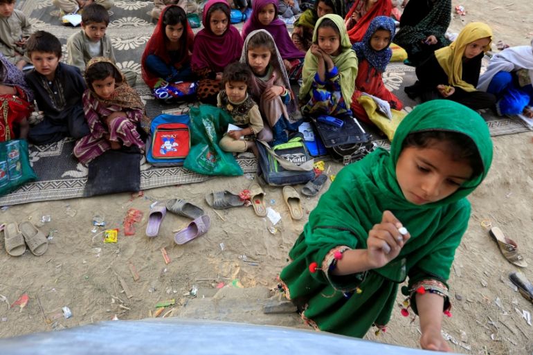 Afghan children study at an open area in Ghani Khel district of Jalalabad