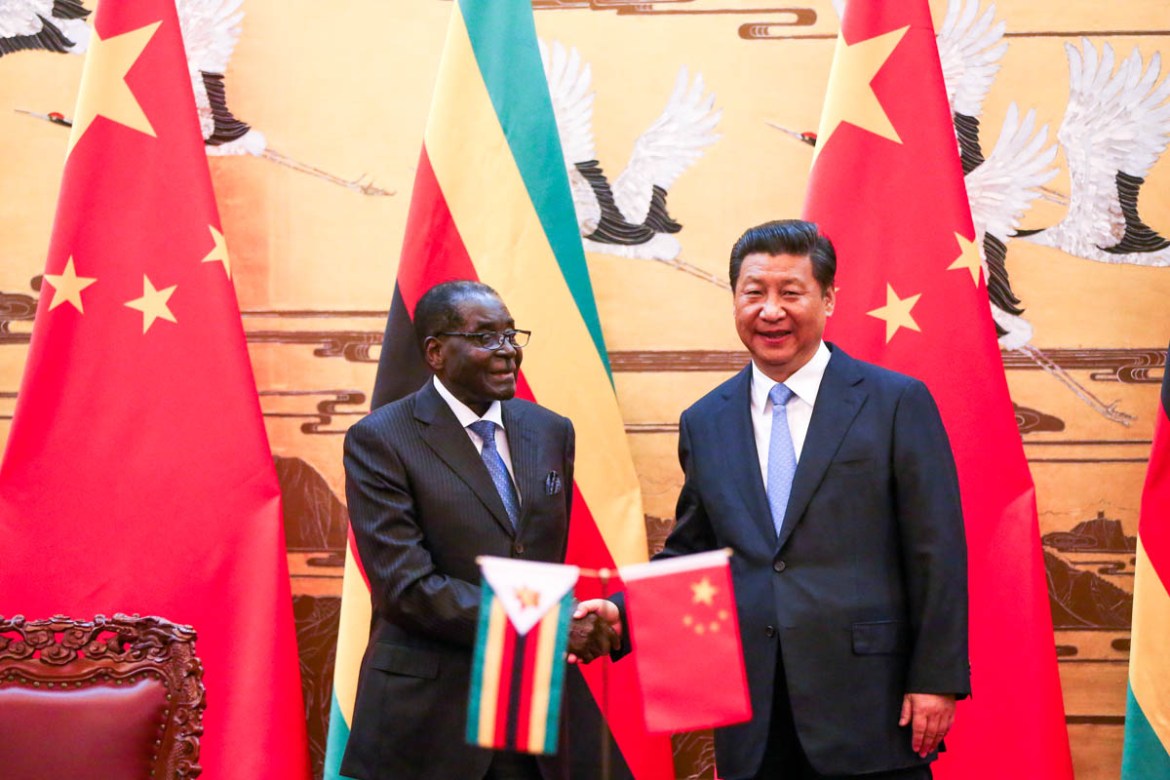 BEIJING, CHINA - AUGUST 25: Zimbabwean President Robert Mugabe (L) and his Chinese counterpart Xi Jinping participate in a signing ceremony at the Great Hall of the People (GHOP) on August 25, 2014 in
