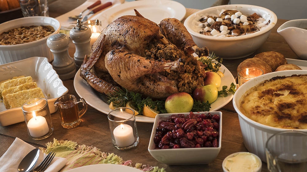
Dining table filled with thanksgiving food [ Getty Images] 
