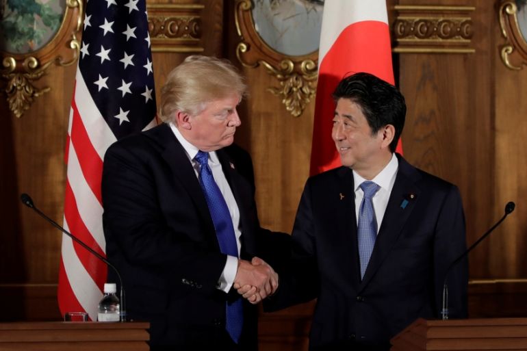U.S. President Donald Trump, left, shakes hands with Shinzo Abe, Japan''s prime minister, during a news conference at Akasaka Palace in Tokyo