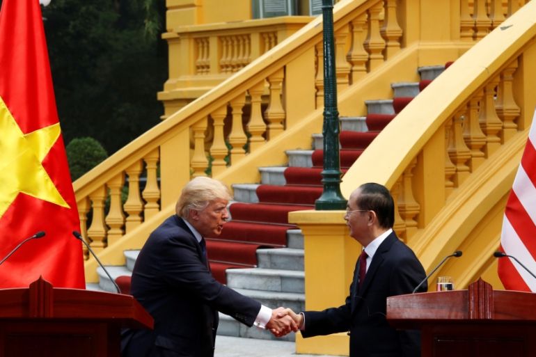 U.S. President Donald Trump and Vietnam''s President Tran Dai Quang shake hand during a news conference at the Presidential Palace in Hanoi