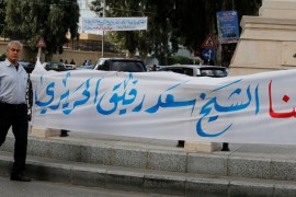 A man walks past a banner in the mainly Sunni Beirut neighbourhood of Tariq al-Jadideh in Beirut
