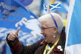 A woman gestures at a pro Independence rally held outside the SNP conference in Glasgow