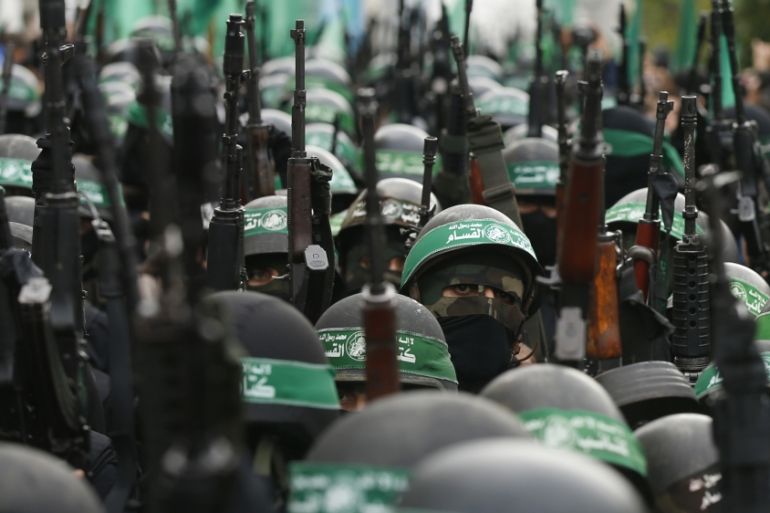 Palestinian members of al-Qassam Brigades take part in a military parade in Gaza City
