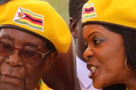 FILE PHOTO: President Robert Mugabe listens to his wife Grace Mugabe at a rally of his ruling ZANU(PF) party in Harare