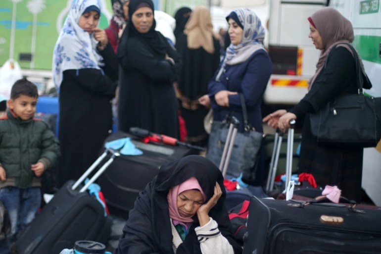 Palestinians wait for travel permits to cross into Egypt, for the first time after Hamas ceded Rafah border crossing to the Palestinian Authority, in Khan Younis in the southern Gaza Strip