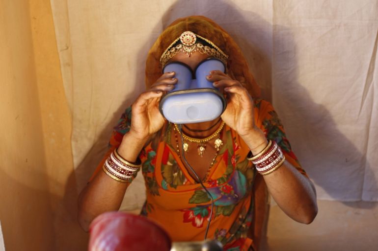 A villager goes through the process of eye scanning for UID database system at an enrolment centre at Merta district in Rajasthan