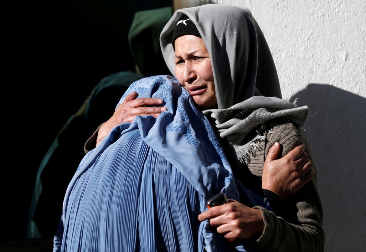 Afghan women mourn inside a hospital compound after a suicide attack in Kabul, Afghanistan. At least 40 people were been killed and dozens wounded in a blast in Kabul at a compound comprising a news a