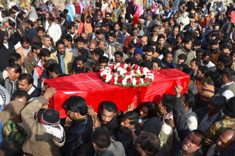 People attend a funeral as they carry the coffin of a victim who was killed after gunmen attacked the Bethel Memorial Methodist Church in Quetta